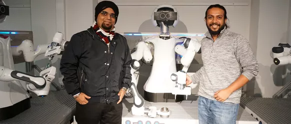 Dr. Saikat Kumar Shome (links) und Dr. Amartya Ganguly (rechts) besuchen die AI.Factory Bavaria in München.